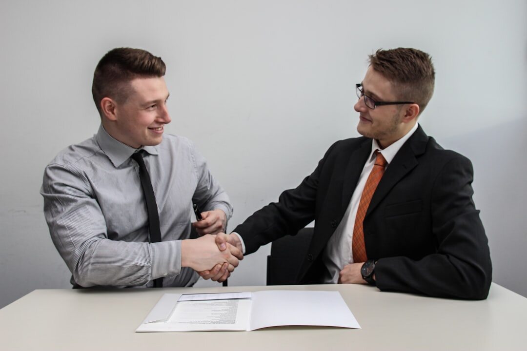 people shaking hands in meeting